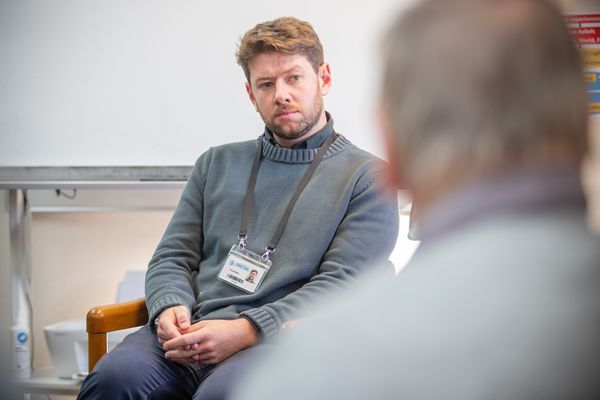 Psychologist sits listening to person